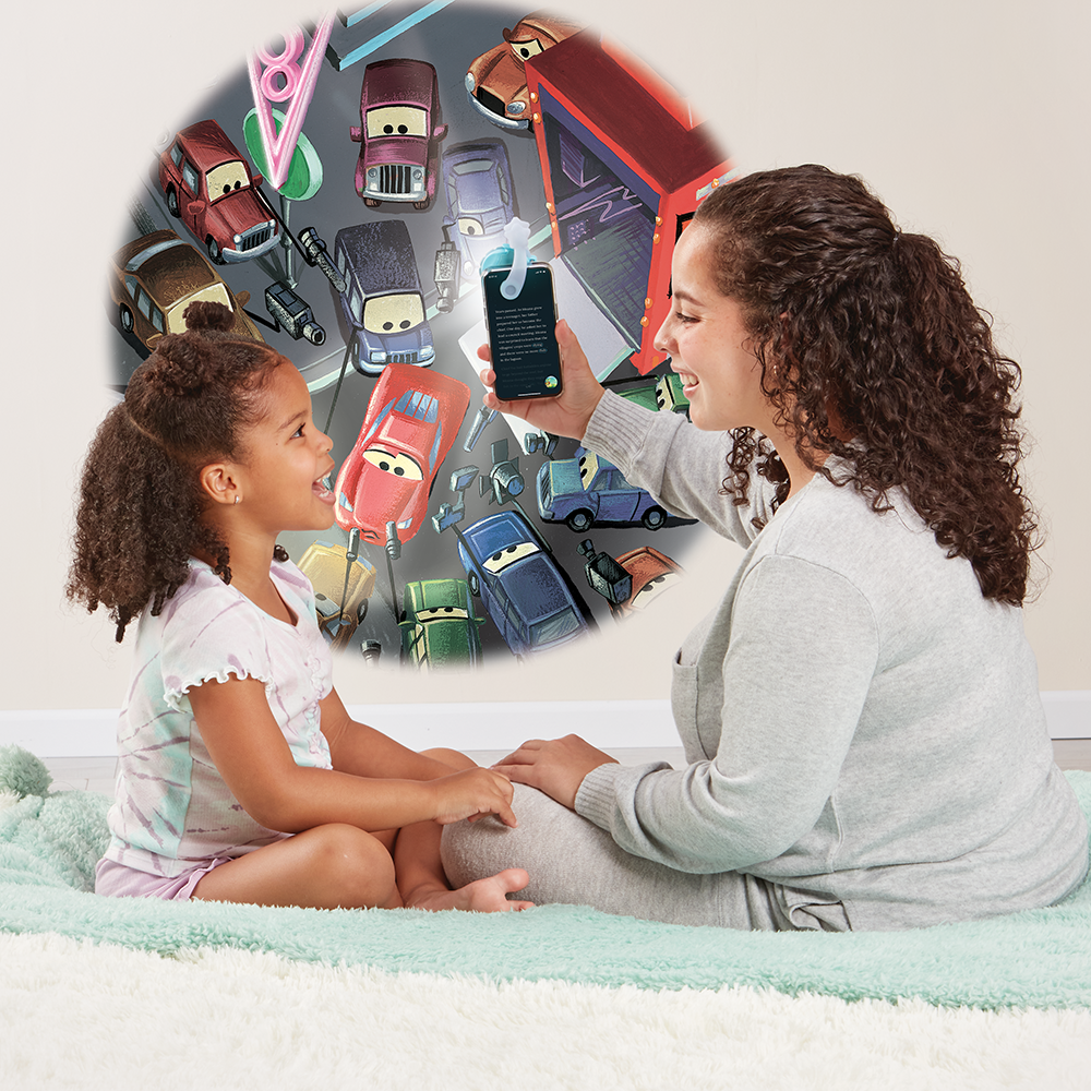 Mom reading to her daughter, using the Moonlite projector to project the story images on the wall