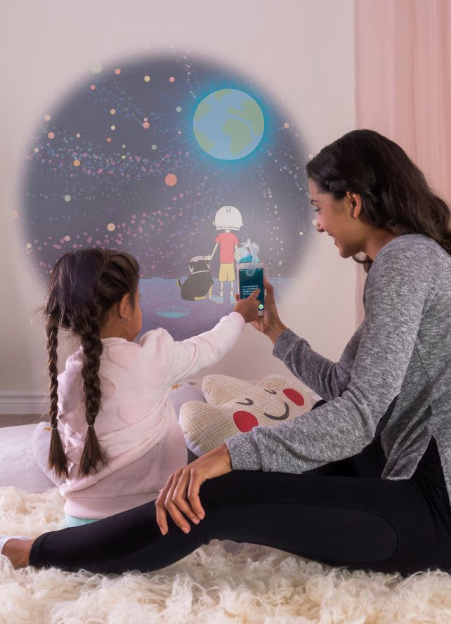 Mother and daughter projecting a Story Book from Moonlite Collection