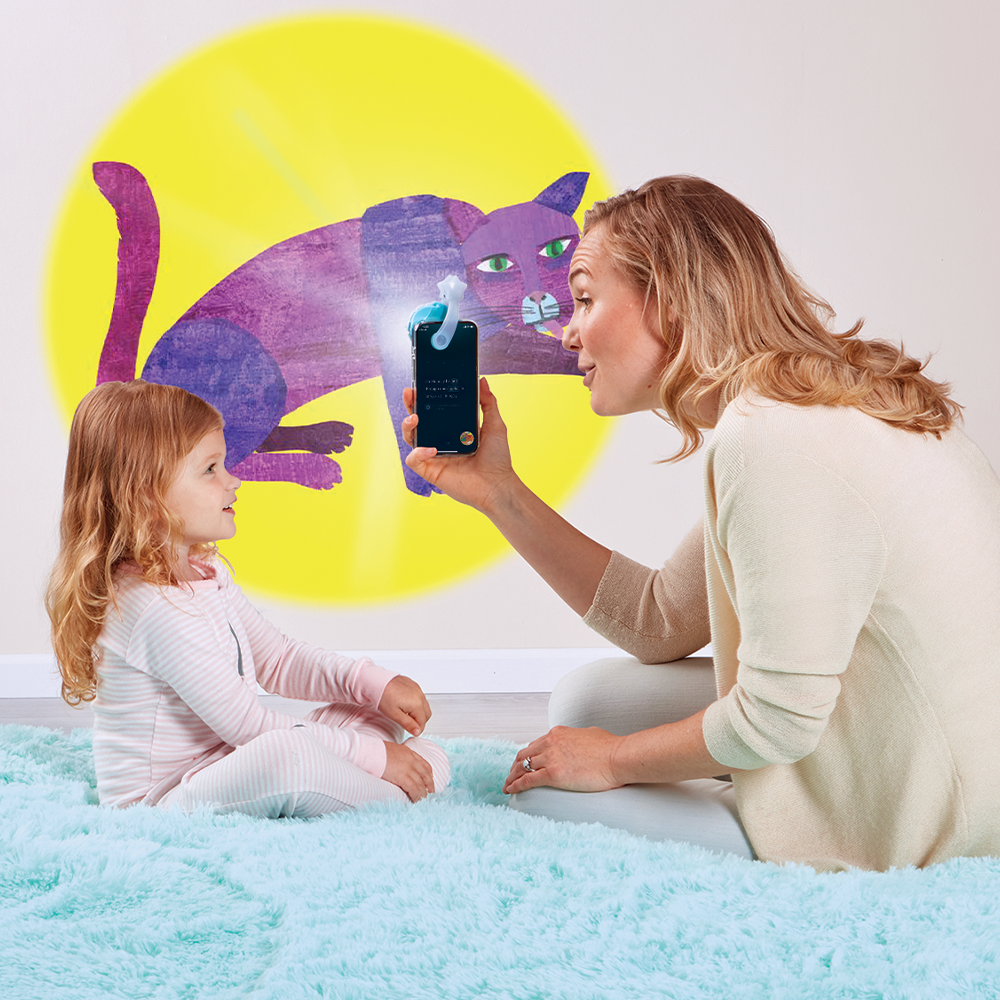 Mother reading to daughter with the Moonlite Storytime Projector