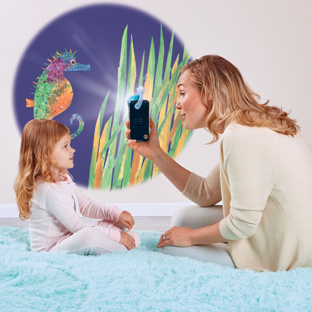 Mother reading to daughter with the Moonlite Storytime Projector