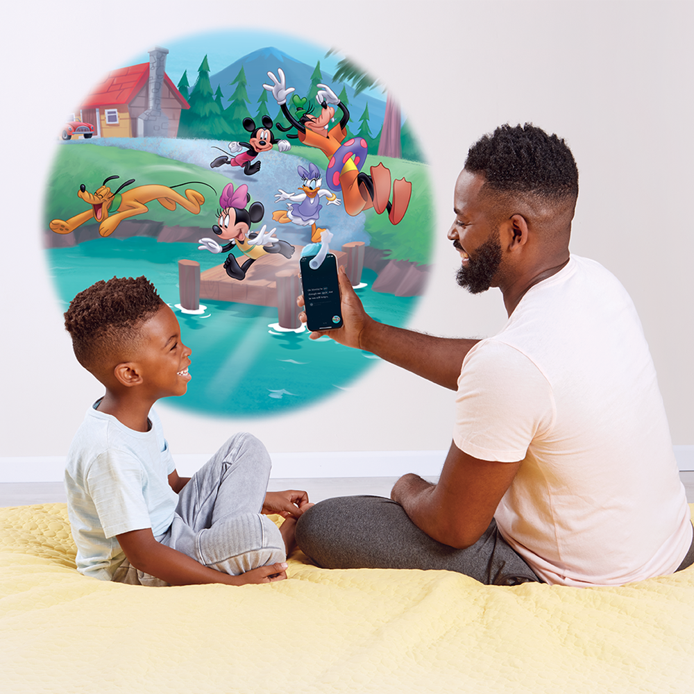 Father reading to his son, using the Moonlite projector to project the story images on the wall