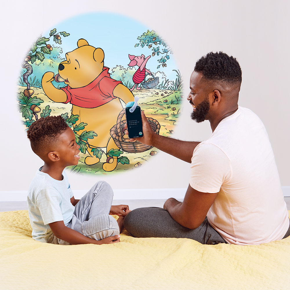 Father and son reading Disney Winnie the Pooh stories with Moonlite Storytime.