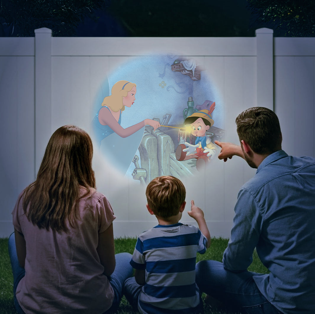 Family using their fence outside at night to use their Moonlite Storytime device